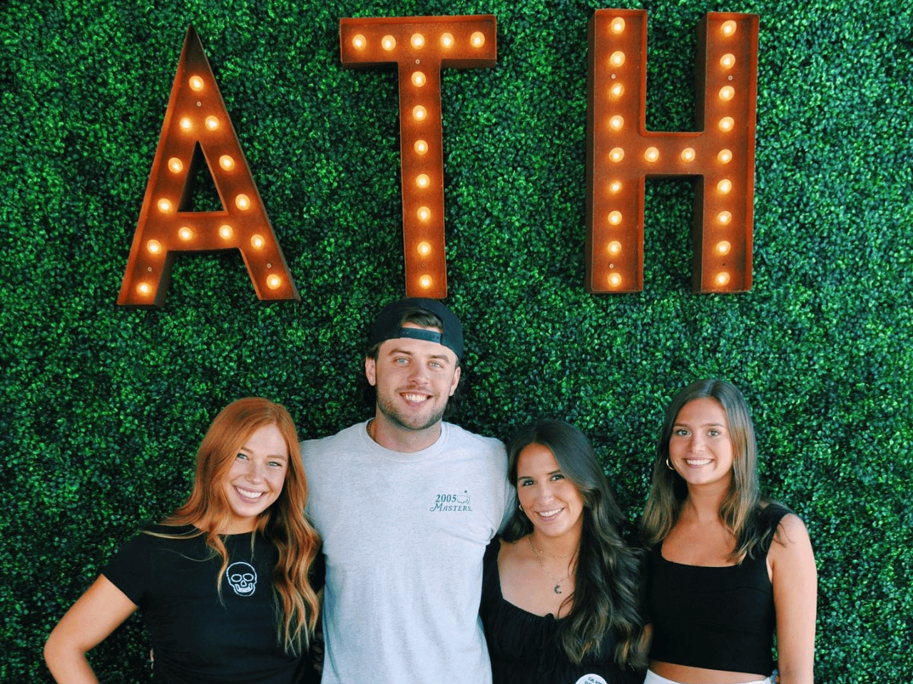 A group of patrons take a picture in front of the ATH sign at Silver Dollar.